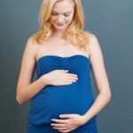 How Does the Mother Provide Nutrition During Pregnancy Image of a pregnant woman eating a variety of healthy foods to provide nutrition for her growing baby