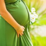 How Are Nutrition Needs Affected During Pregnancy Image of a pregnant woman eating healthy foods to support her changing nutrition needs during pregnancy