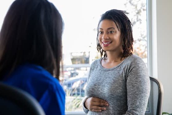 Symptoms of Pregnancy Image: Woman holding positive pregnancy test, illustrating common symptoms of pregnancy like nausea and fatigue