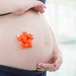 What Is Nesting in Pregnancy Image of a pregnant woman demonstrating nesting behaviors in preparation for childbirth. What is nesting in pregnancy