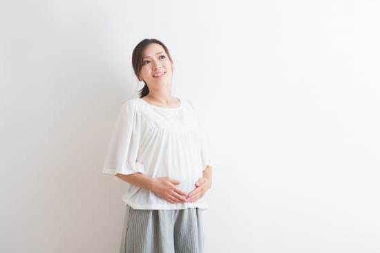 Cramping During Pregnancy Image of pregnant woman holding her belly and experiencing cramping during pregnancy