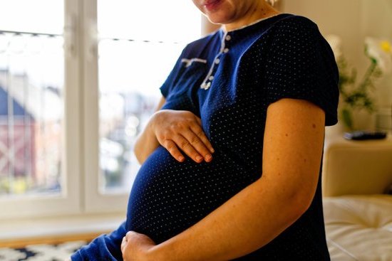 Pregnant woman experiencing abundant discharge throughout pregnancy – consult doctor for guidance